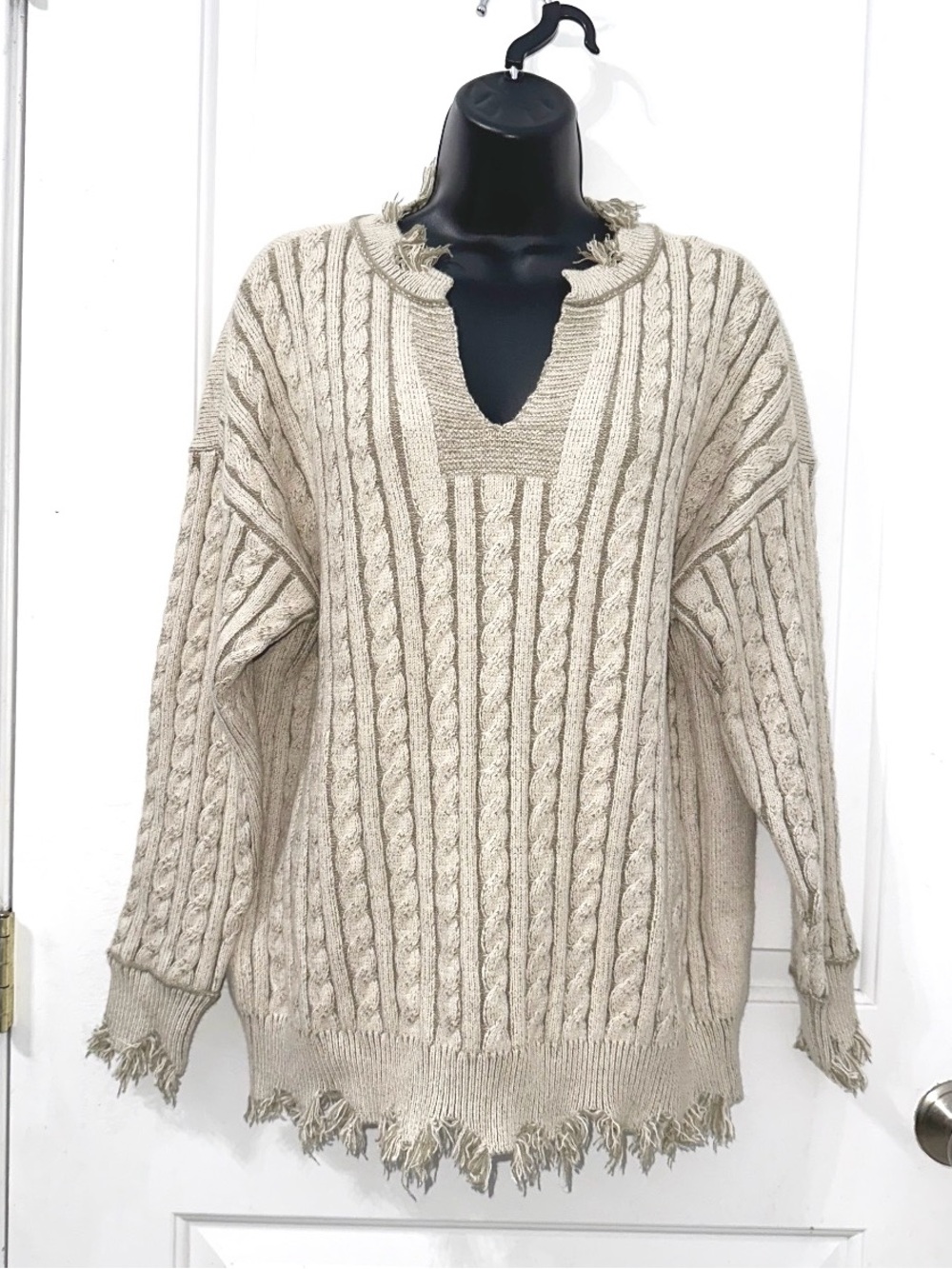 BKE Beige/Tan cable-knit sweater featuring a deep V-neckline & Frayed hem